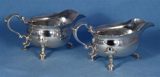 A pair of George II silver sauce boats, attributed to Joseph Sanders, length 195mm, weight 24.4 oz/760grms.